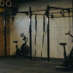Industrial-style gym with exercise bikes, rings, and pull-up bars in Angola.
